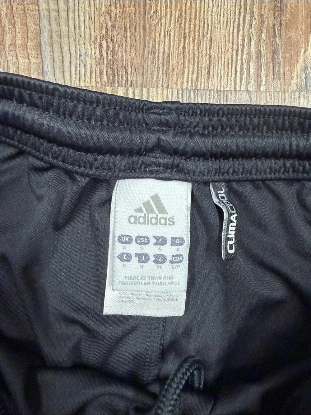 Adidas black shorts with baby pink and white stripes on sides, size S